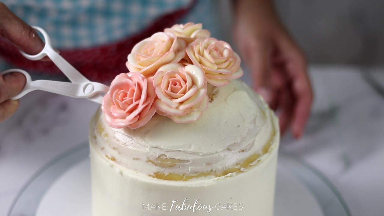 adding flower on top of the cake