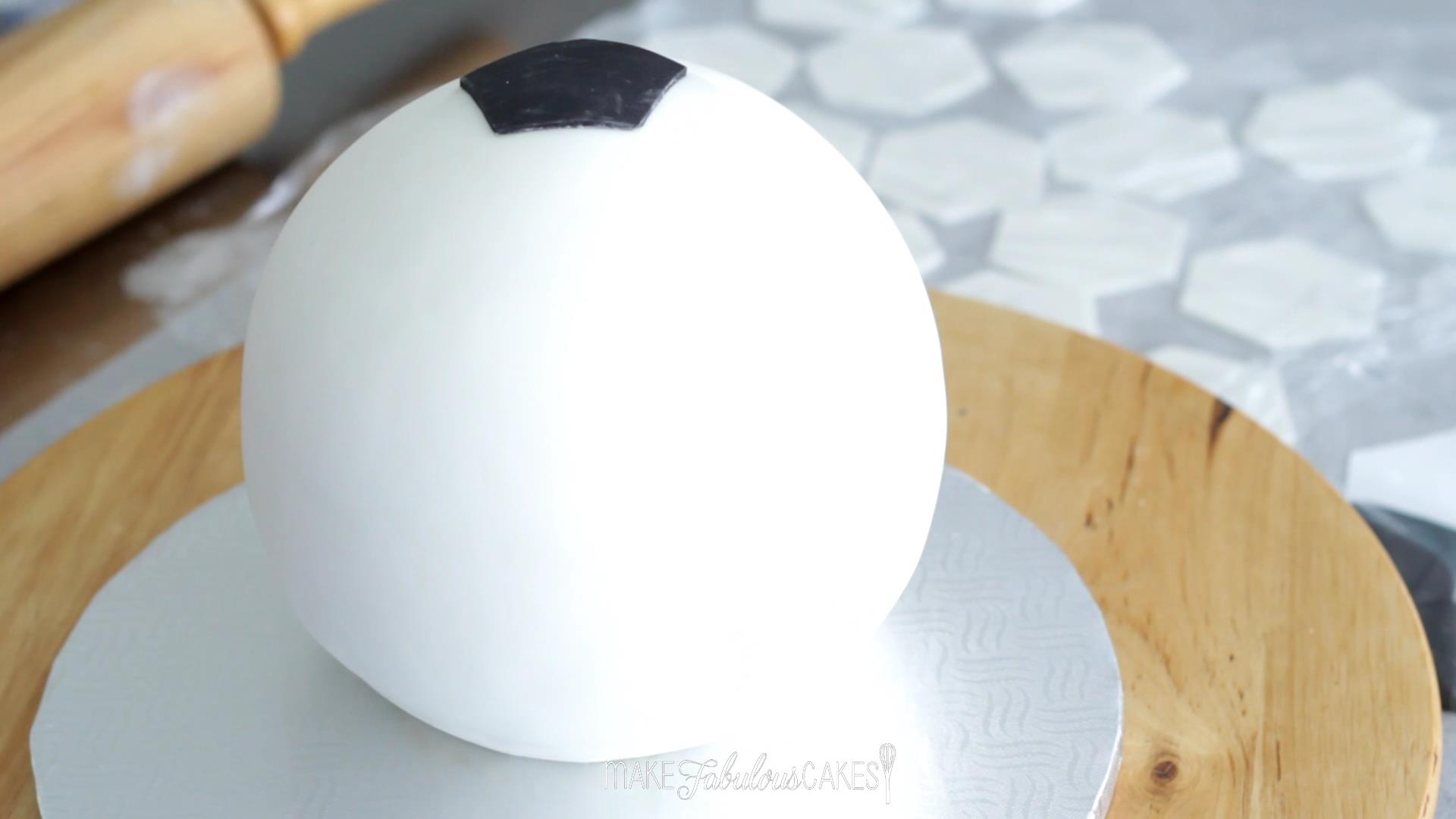 adding the soccer ball pattern on the cake