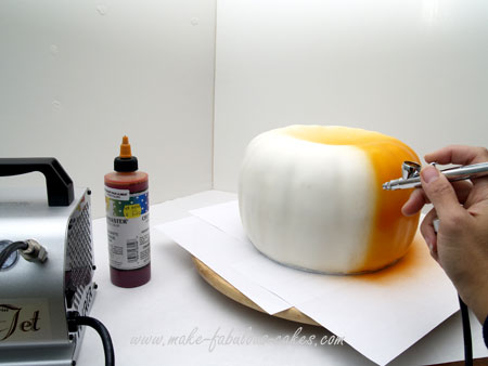airbrushing pumpkin cake