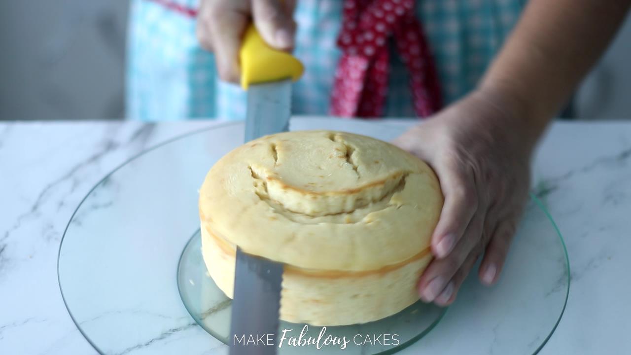 cutting dome of cake with serrated knife