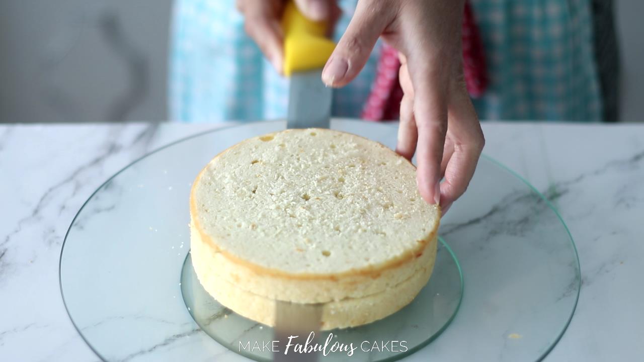 cutting cake in half with serrated knife