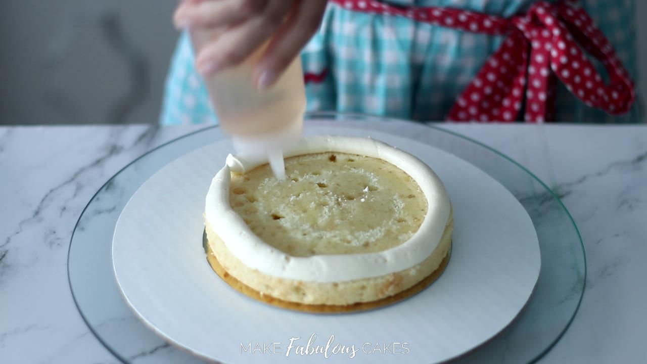 adding simple syrup to cake