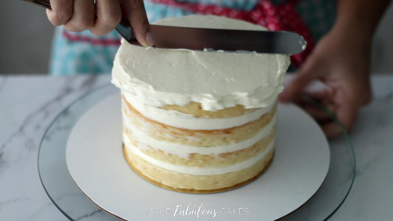 frosting top of cake with buttercream