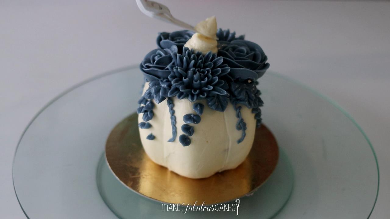 mini pumpkin cake with buttercream flowers