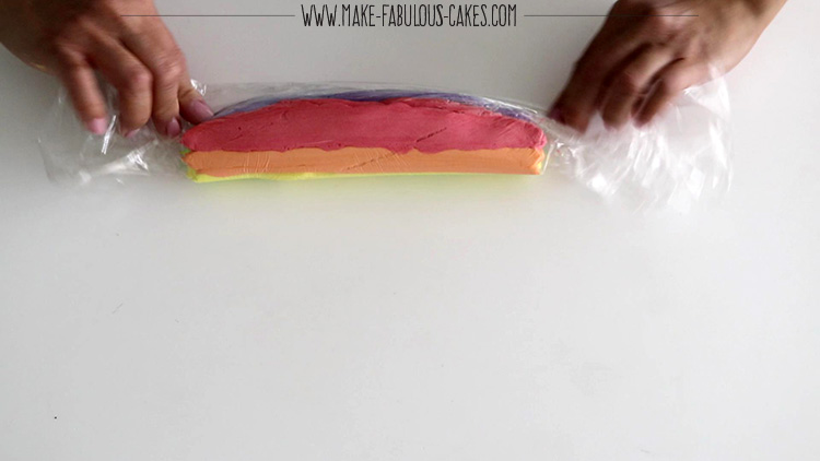 rolling the plastic wrap over buttercream to create an icing plug