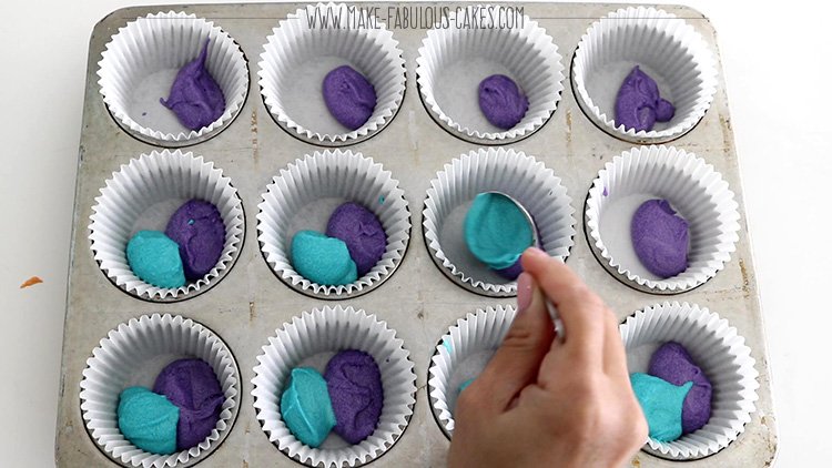 adding rainbow colored batter one tablespoon at a time