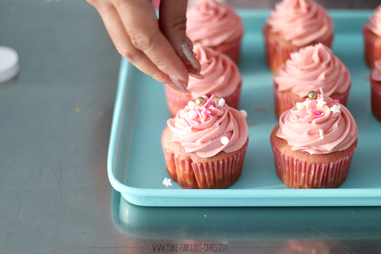 adding sprinkles on cupcakes