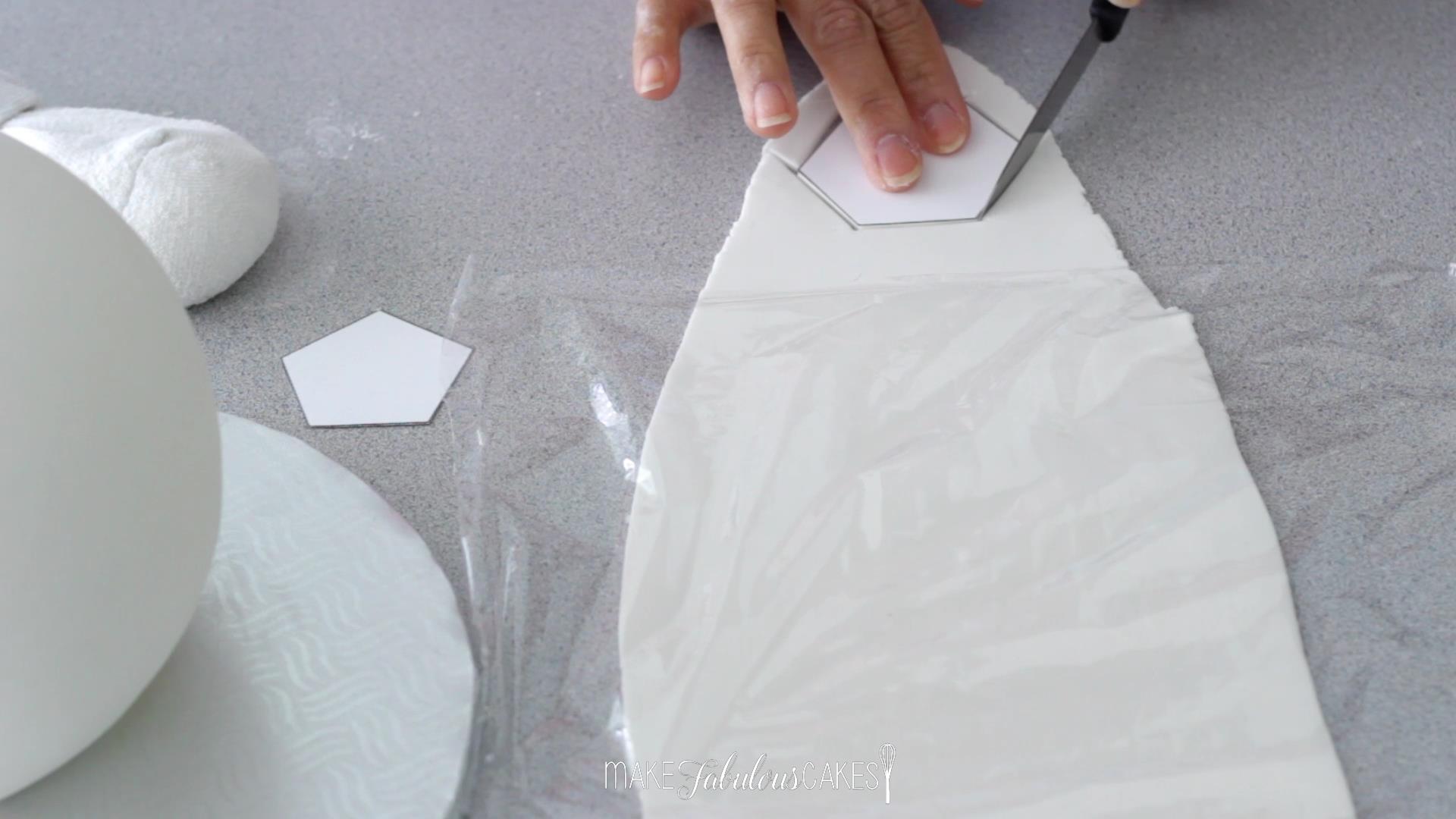 cutting the soccer ball template from fondant