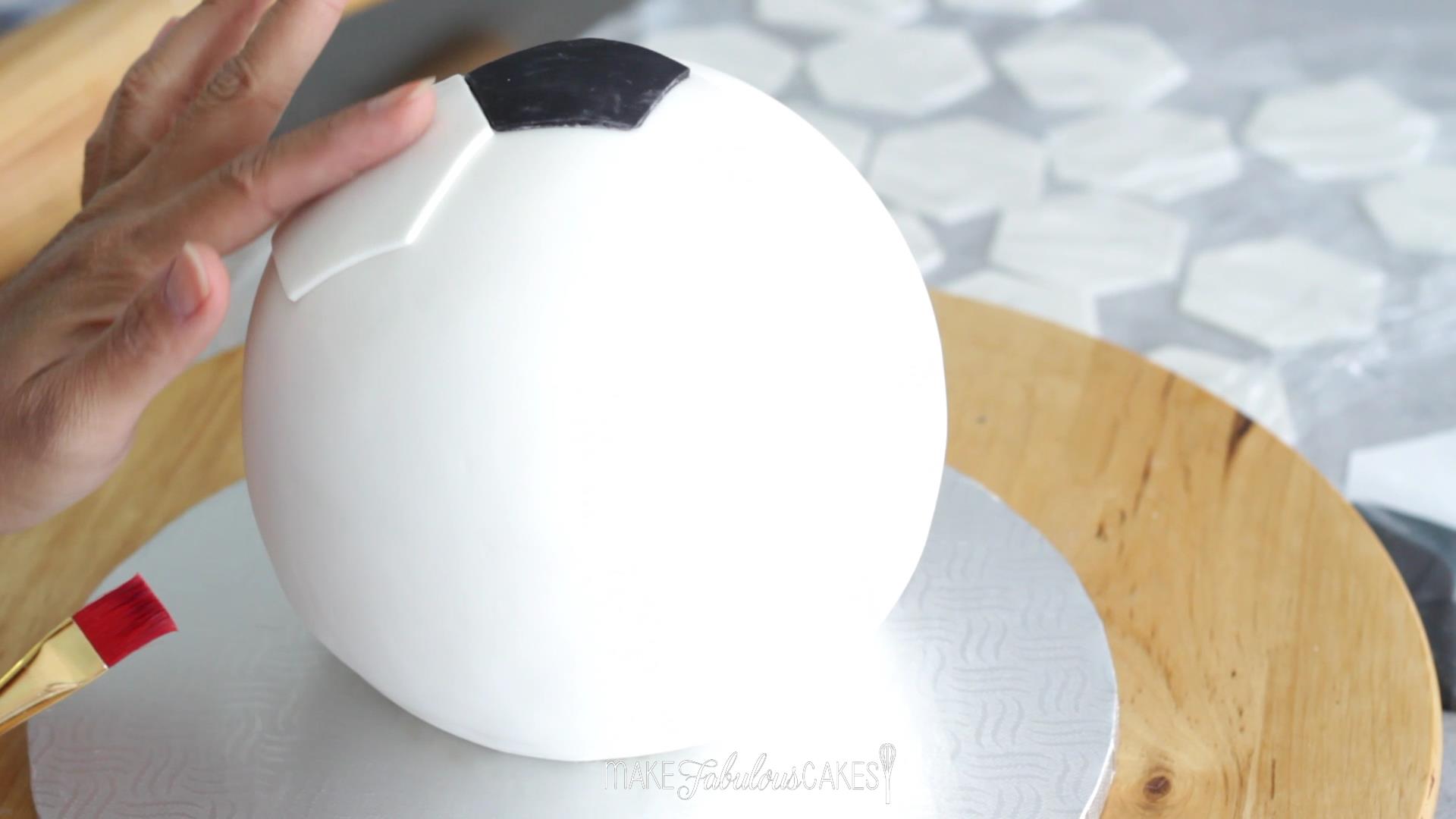 adding the soccer ball pattern on the cake