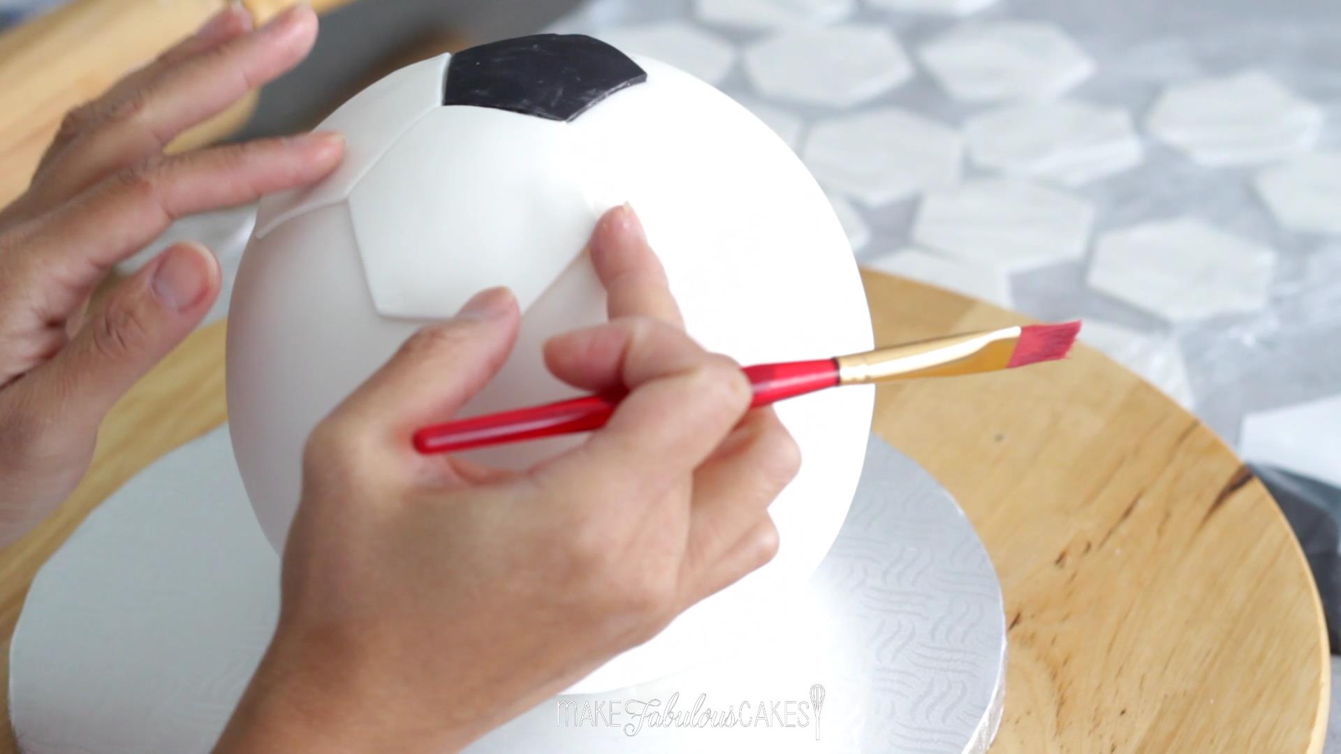 adding the football pattern on the cake