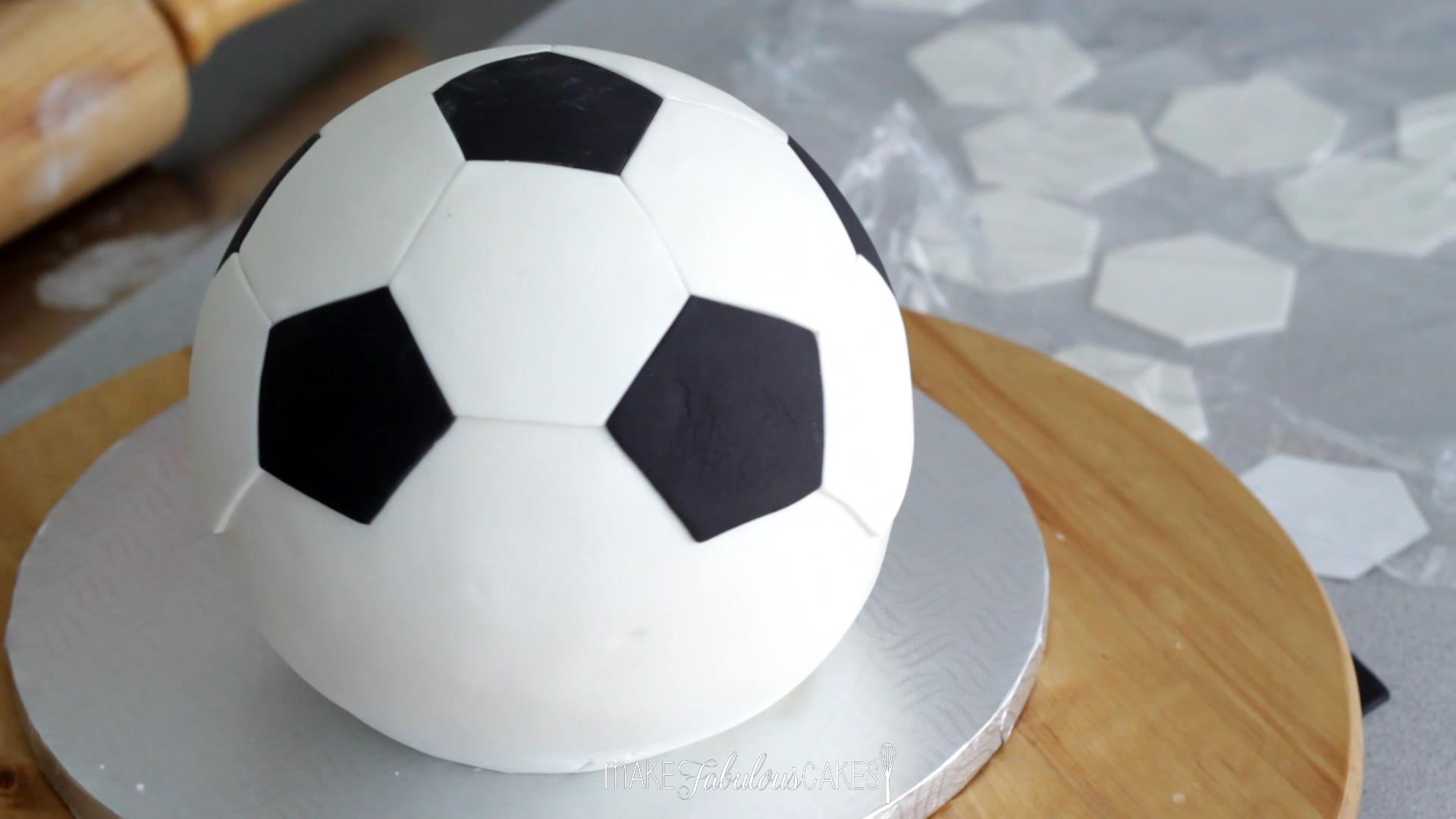 adding the football pattern on the cake