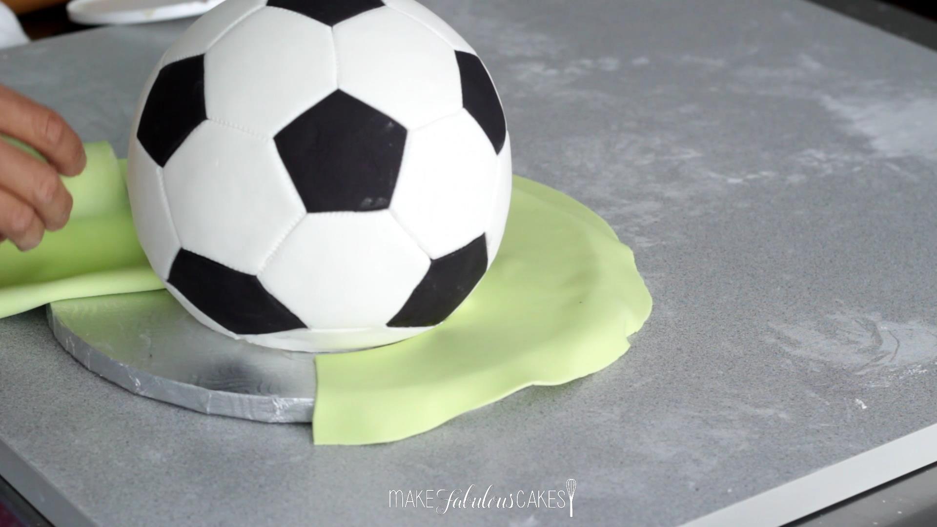 covering the football cake board with fondant