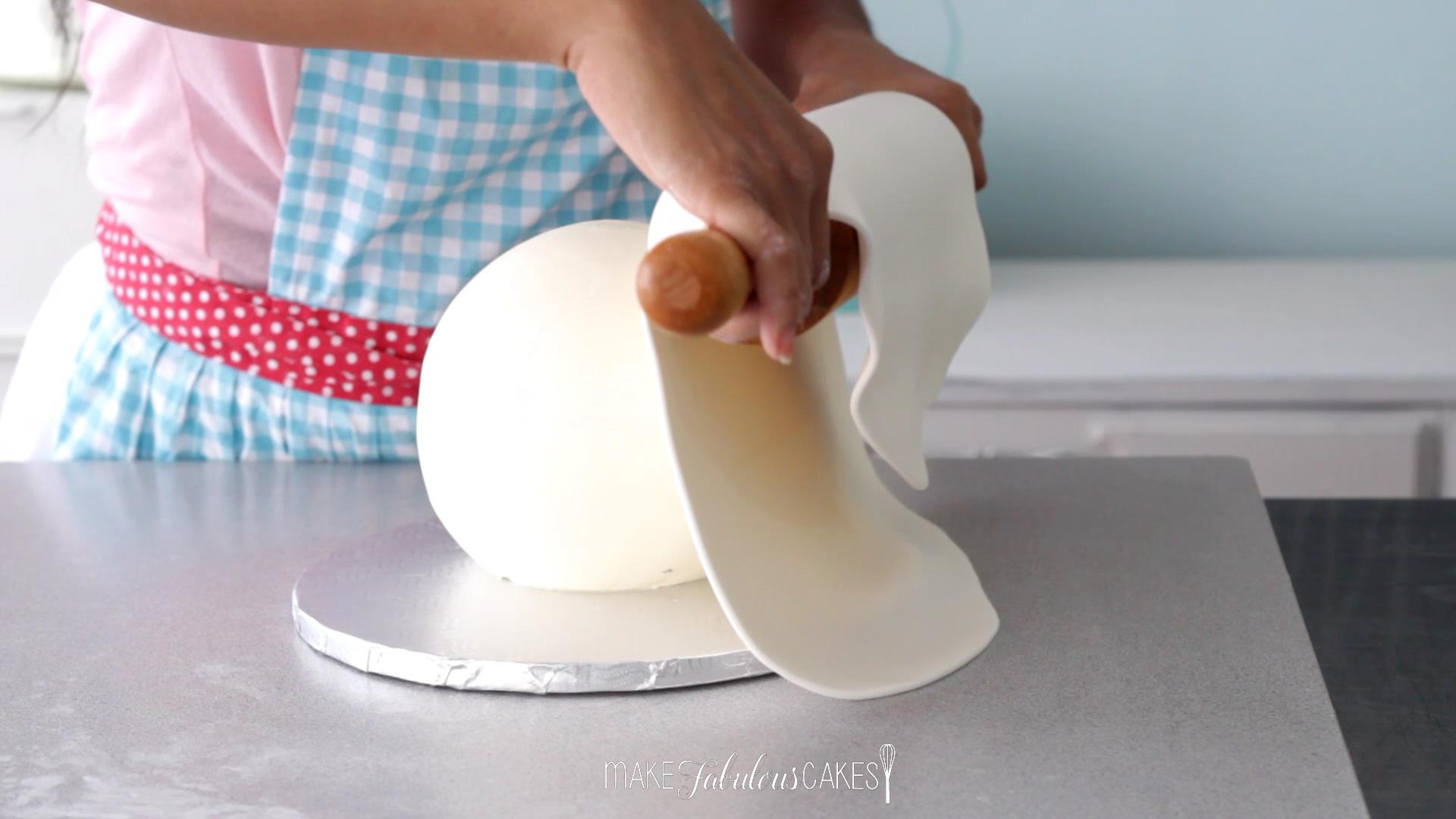 placing the fondant on the ball cake